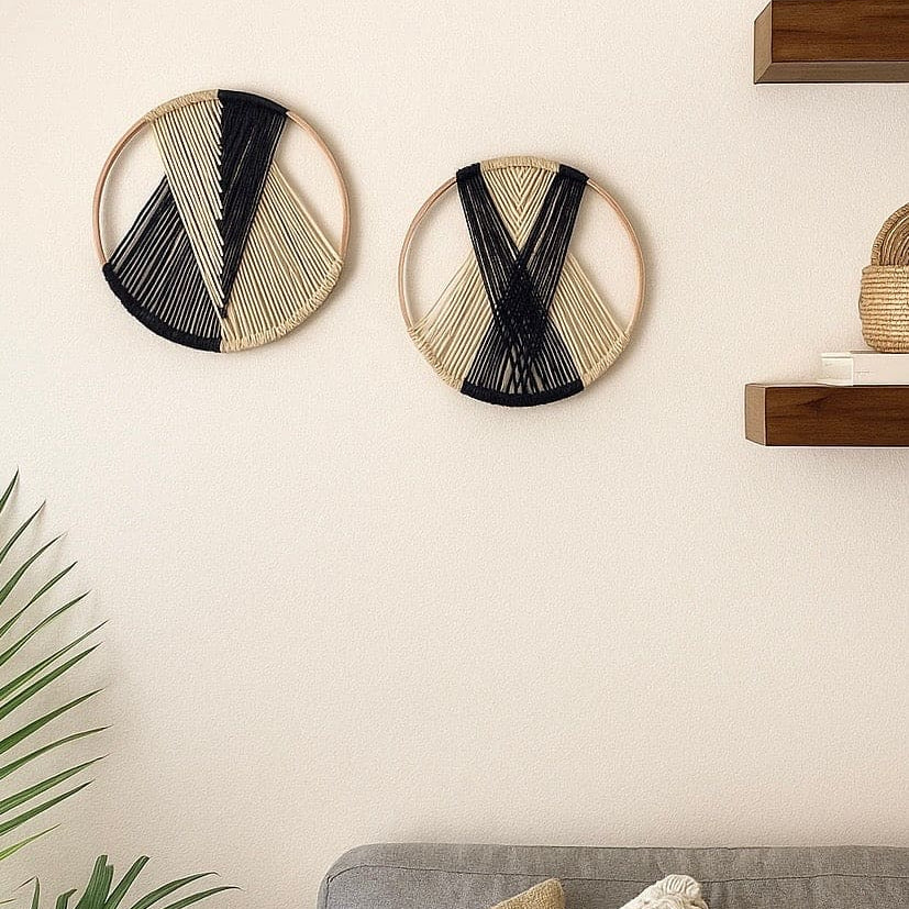 Decorative wall art with geometric patterns on a neutral wall above a sofa.